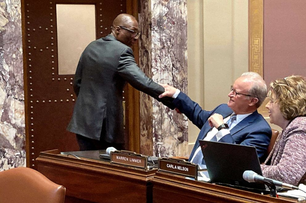 PHOTO: Minnesota Senate President Bobby Joe Champion, left, and Sen. Warren Limmer, joke with each other on the floor of the Minnesota Senate on Feb. 21, 2023,