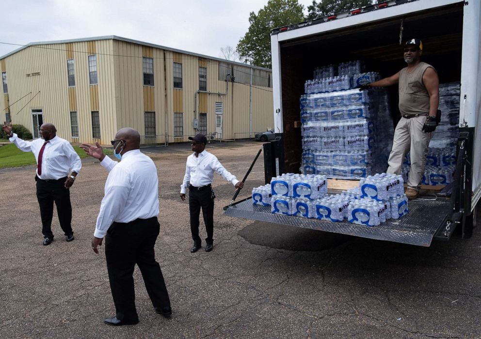 PHOTO: In this Sept. 4, 2022, file photo, members of Progressive Morningstar Baptist Church direct people to get bottled water following a Sunday morning service in Jackson, Miss.