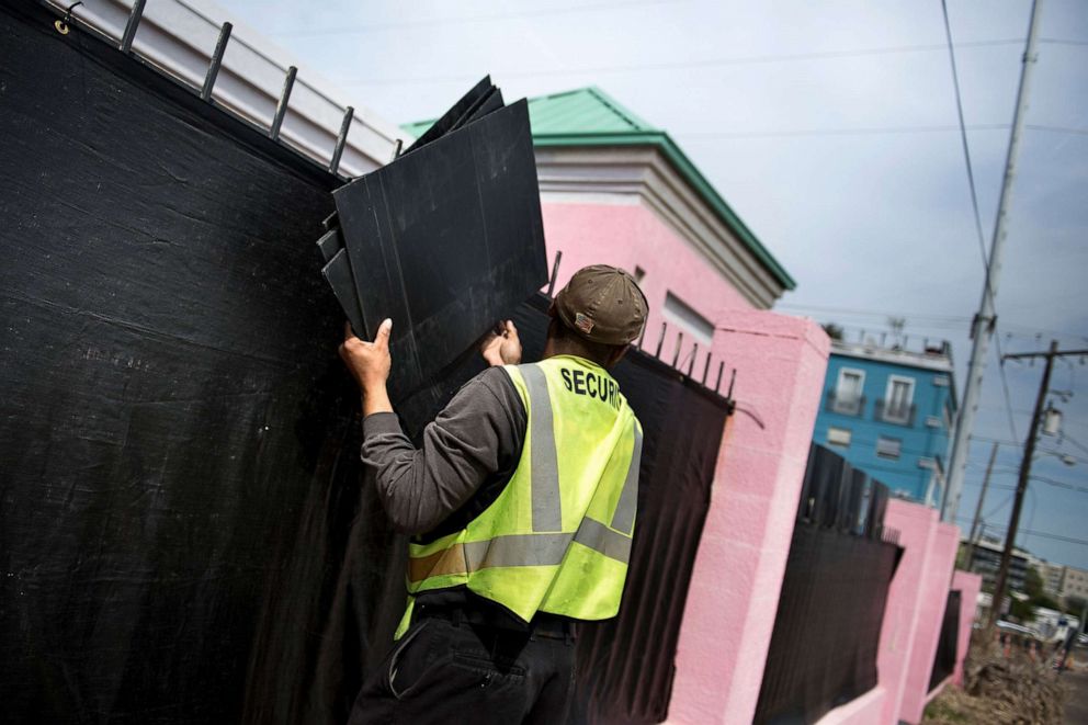 PHOTO:A security guard removes boards used for privacy from a fence outside the Jackson Women's Health Organization, the last abortion clinic in Mississippi, after patients left for the day, April 5, 2018, in Jackson, Miss.