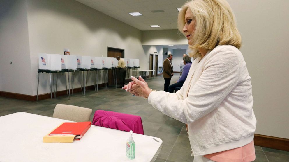 PHOTO: Republican Attorney General Lynn Fitch, rubs hand sanitizer on her hands after voting in the party presidential primary in Ridgeland, Miss., March 10, 2020.
