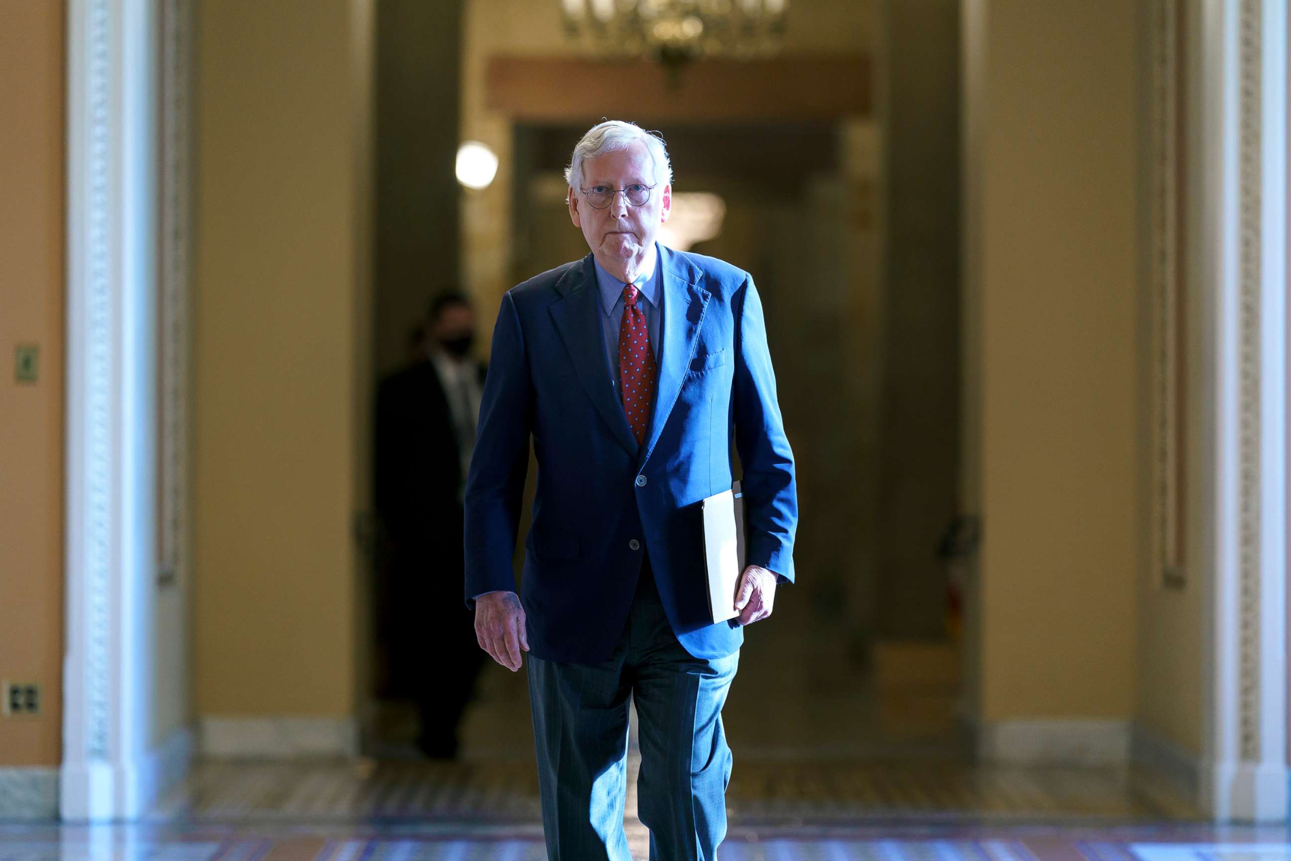 PHOTO: Senate Minority Leader Mitch McConnell walks to the chamber for a test vote on a government spending bill, at the Capitol, Sept. 27, 2021. 