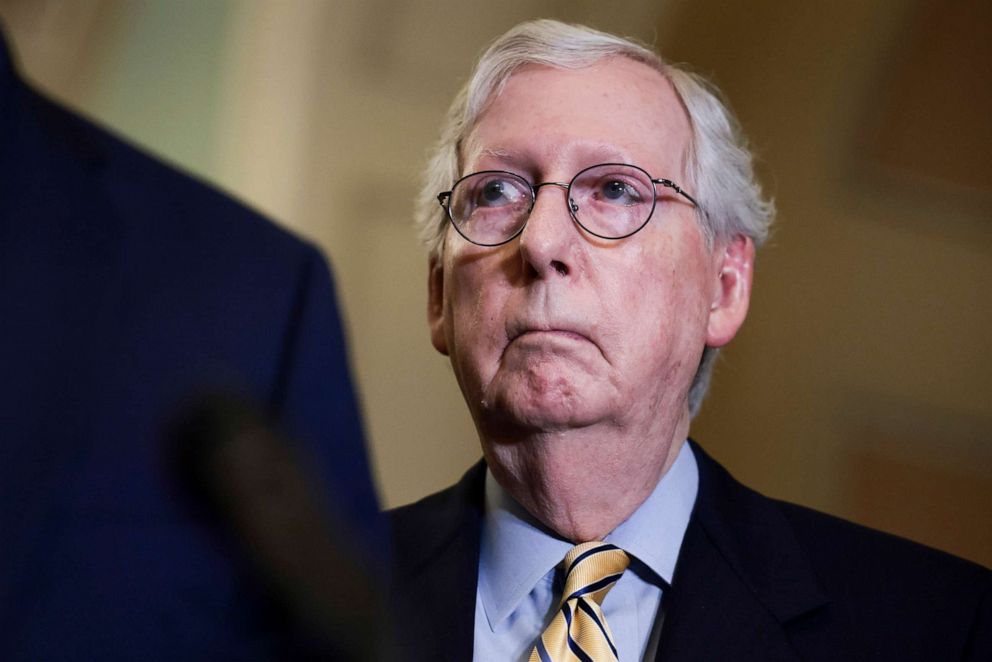 PHOTO: Senate Minority Leader Mitch McConnell listens as Senate Minority Whip John Thune addresses reporters following a weekly Republican policy meeting at the Capitol, Sept. 21, 2021.