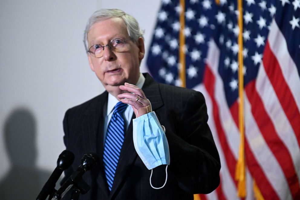 PHOTO: Senate Majority Leader Mitch McConnell holds a face mask while participating in a news conference at the U.S. Capitol in Washington, Oct. 20, 2020.