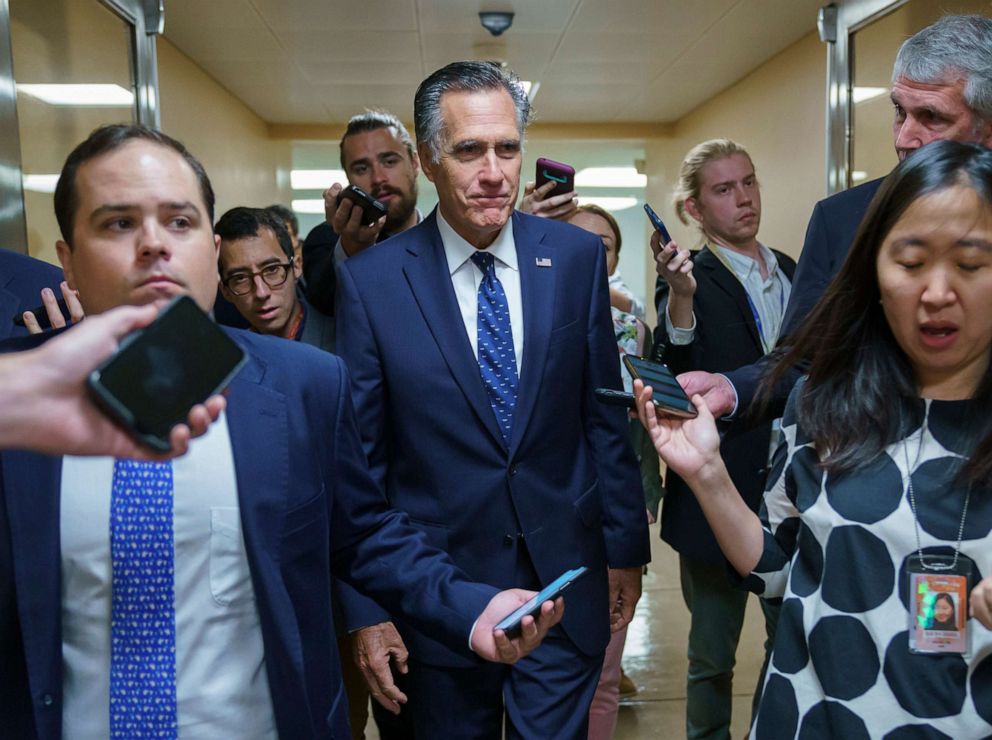 PHOTO: Sen. Mitt Romney is surrounded by reporters as he walks to the Senate chamber for votes, at the Capitol in Washington, D.C., June 10, 2021.
