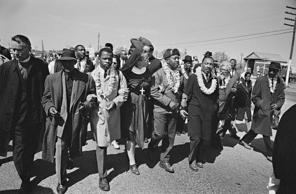 PHOTO: File photo of Dr. Martin Luther King Jr, right, arm in arm with Reverend Ralph Abernathy, center, leads marchers as they begin the Selma to Montgomery civil rights march from Brown's Chapel Church in Selma, Ala. on March 21, 1965. 