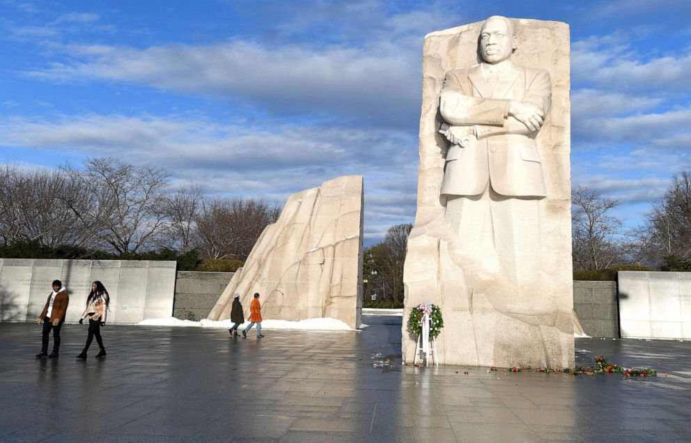 PHOTO: Visitors walk past the Martin Luther King, Jr. Memorial as the sun breaks through clouds after a stormy night, in Washington, D.C., Jan. 17, 2022.