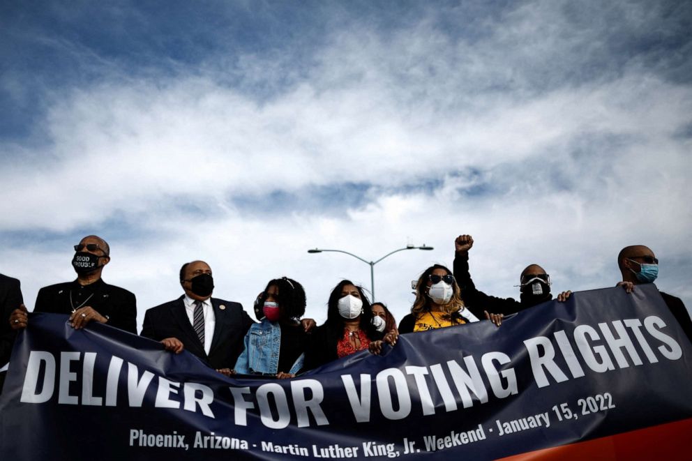 PHOTO: Martin Luther King III, the eldest son of the late civil rights activist Martin Luther King Jr. and family hold a banner during a demonstration to press for voting rights in Phoenix, Jan. 15, 2022.  