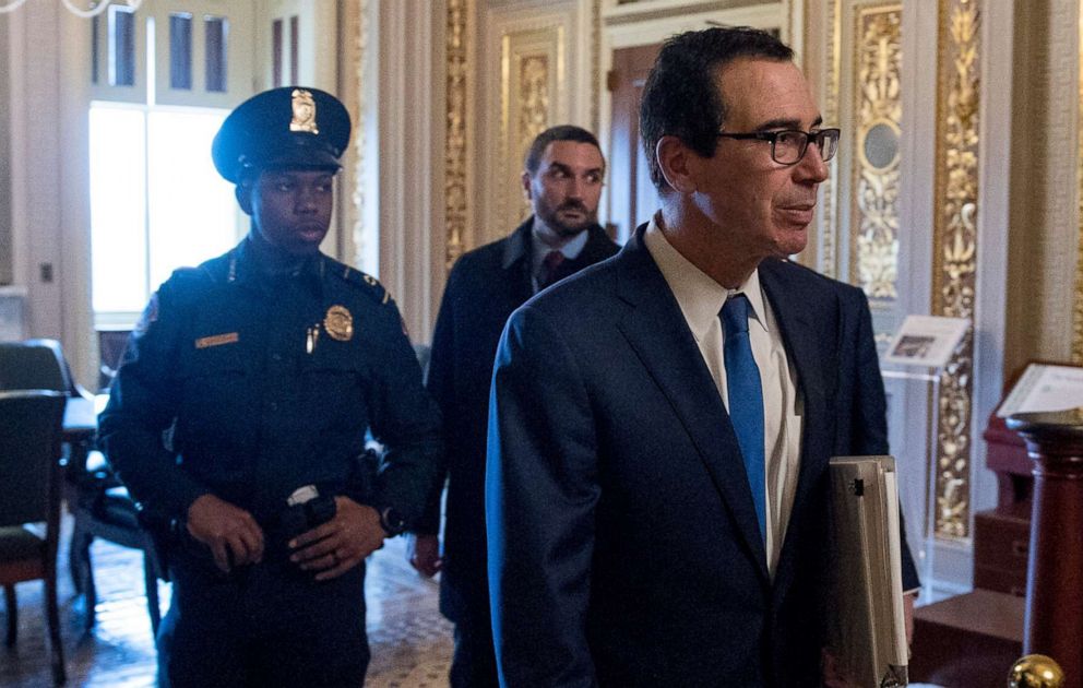 PHOTO: Treasury Secretary Steven Mnuchin walks to a meeting with Senate Minority Leader Sen. Chuck Schumer in his office on Capitol Hill March 23, 2020, in Washington. The Senate is working to pass a coronavirus relief bill.