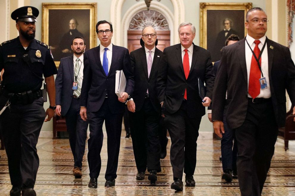 PHOTO: Treasury Secretary Steven Mnuchin, left, with White House Legislative Affairs Director Eric Ueland and acting White House chief of staff Mark Meadows, walks to the offices of Senate Majority Leader Mitch McConnell on Capitol Hill, March 24, 2020.