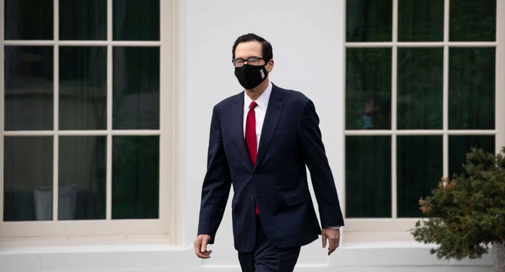 PHOTO: Treasury Secretary Steven Mnuchin wears a mask as he walks on the grounds of the White House, May 14, 2020.