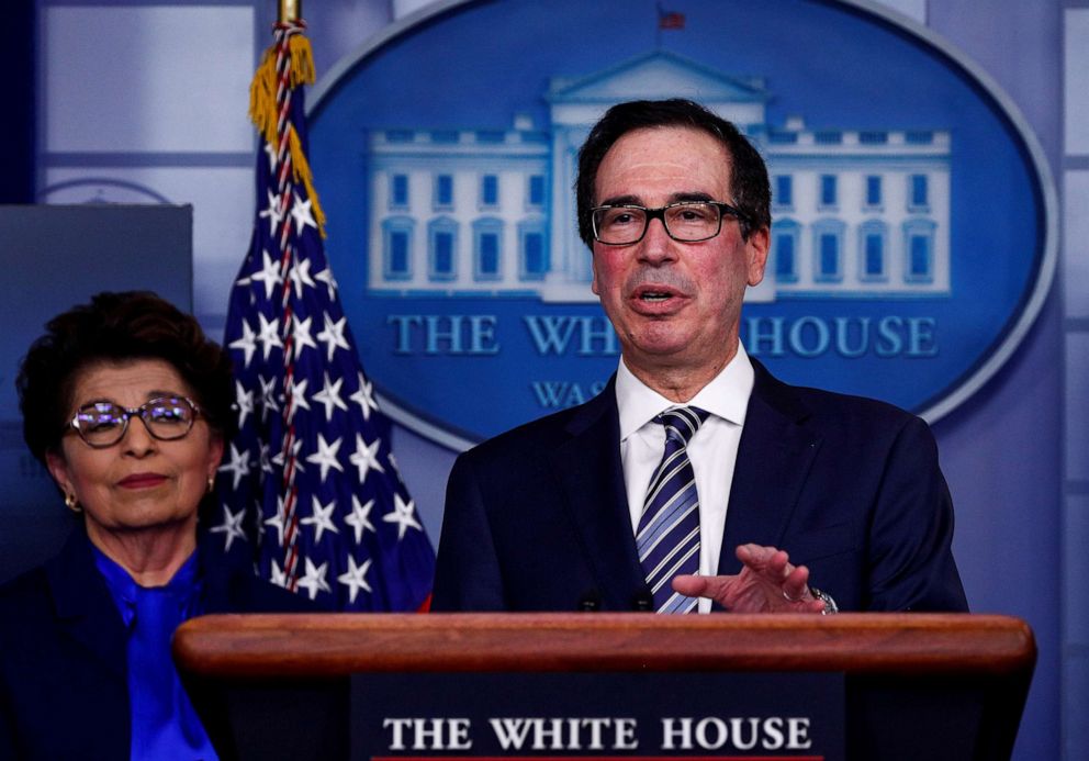 PHOTO: Treasury Secretary Steven Mnuchin discusses details for economic relief during the daily coronavirus response briefing as Small Business (SBA) Administrator Jovita Carranza listens at the White House in Washington, April 2, 2020. 