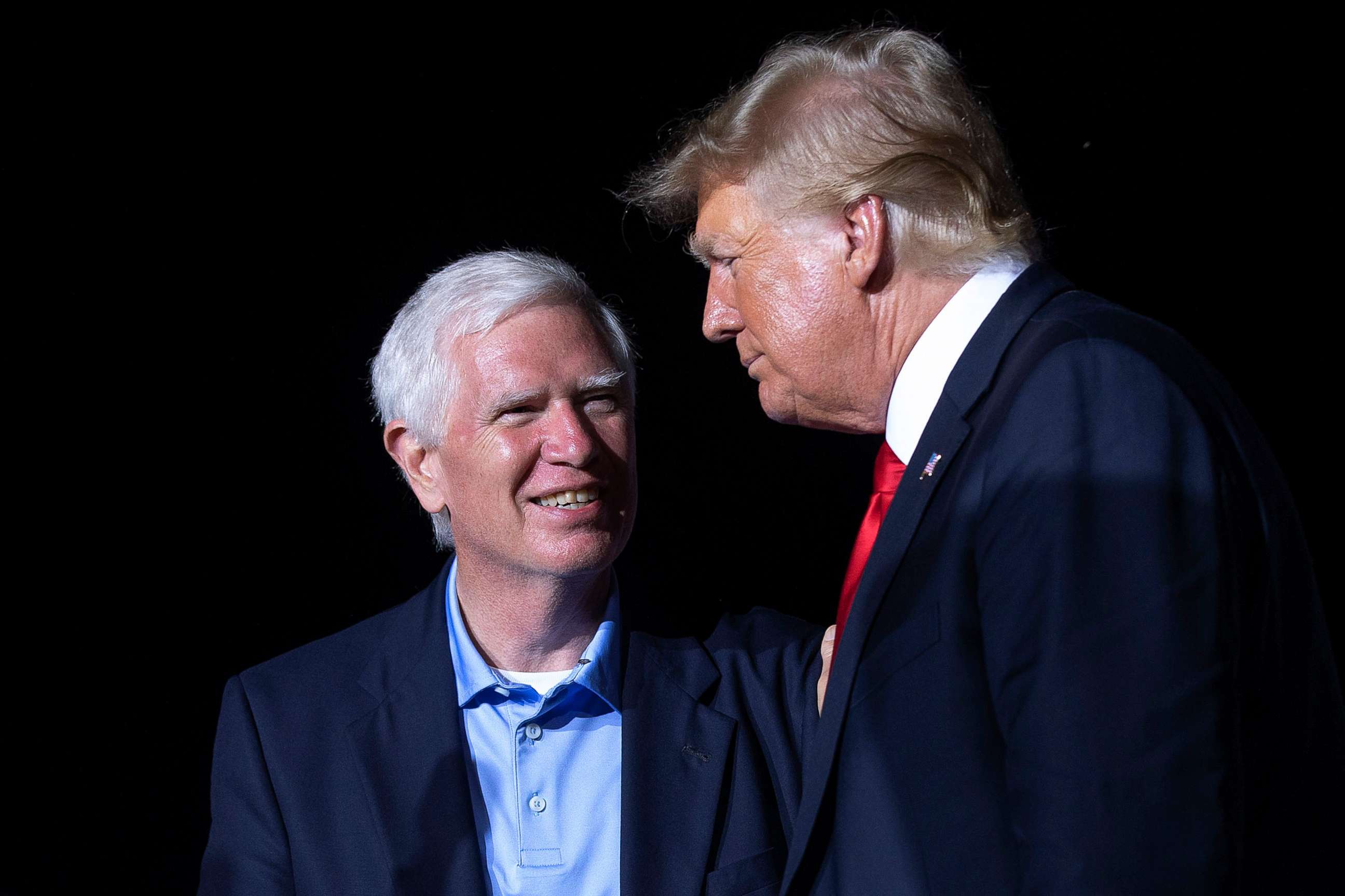 PHOTO: Former President Donald Trump welcomes Rep. Mo Brooks to the stage during a "Save America" rally at York Family Farms, Aug. 21, 2021, in Cullman, Alabama.