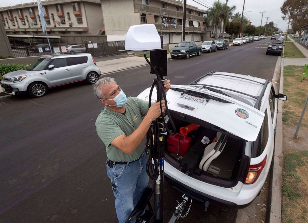 PHOTO: Orange County Public Library warehouse manager Sal Cervantes manually raises a 30-foot WiFi antenna in Midway City, Calif., Oct. 22, 2020, in an effort to help neighborhoods where residents lack an internet connection.