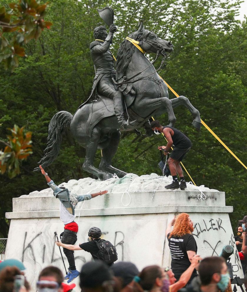 PHOTO: Protesters attempt to pull down the statue of President Andrew Jackson in the middle of Lafayette Park in front of the White House during racial inequality protests in Washington, June 22, 2020.