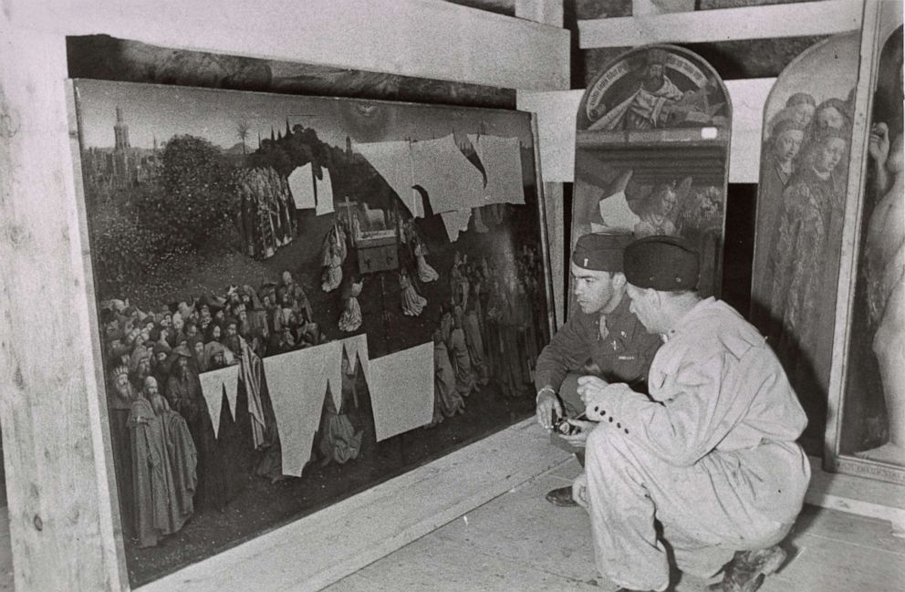 PHOTO: Monuments Men Lt. Daniel J. Kern and German conservator Karl Sieber examine Jan van Eyck’s Adoration of the Mystic Lamb, also known as the Ghent Altarpiece, 1945.