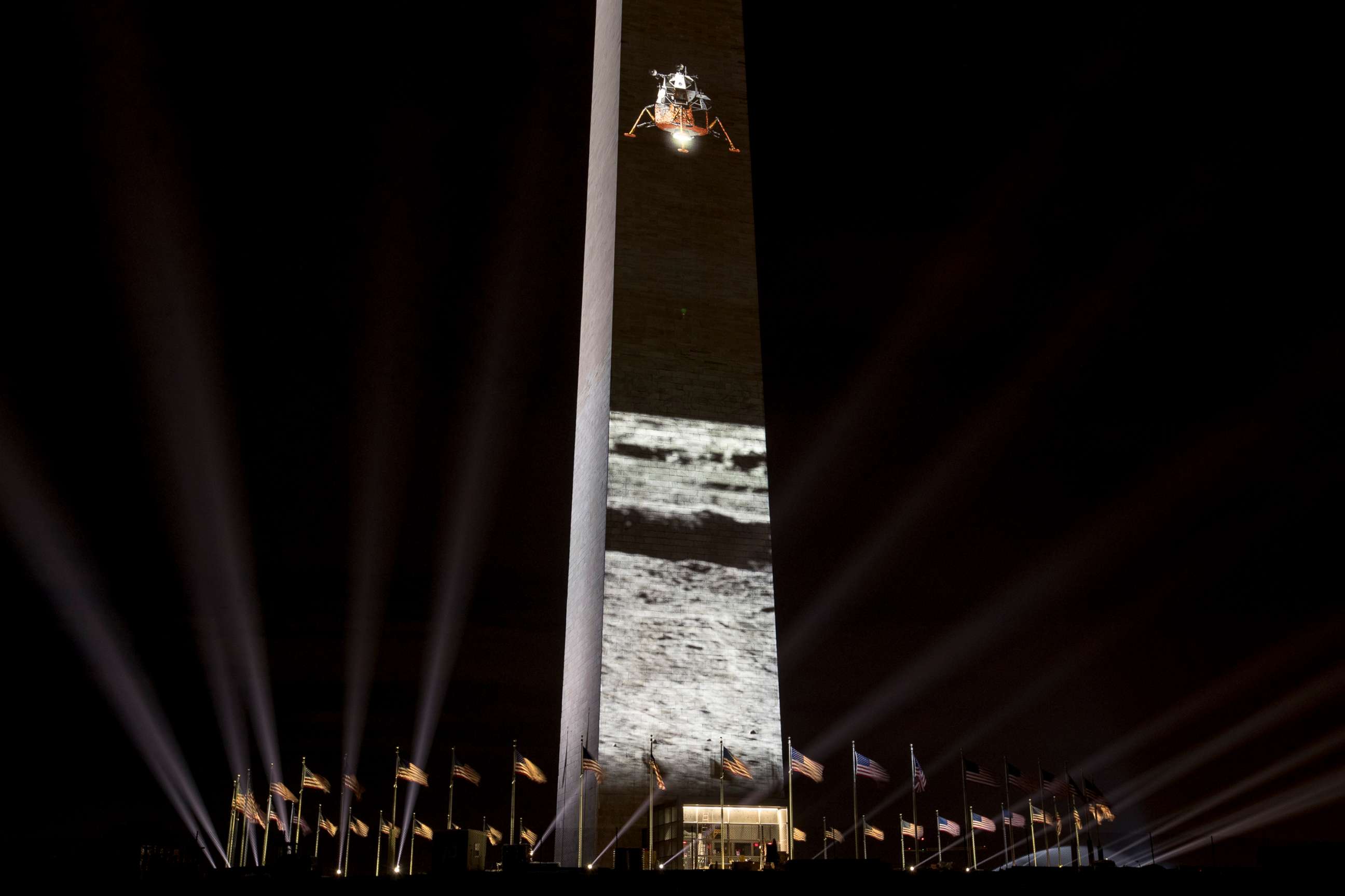PHOTO: A spacecraft landing on the moon is projected on the east face of the Washington Monument in Washington, July 17, 2019, in celebration of the 50th anniversary of the Apollo 11 moon landing.