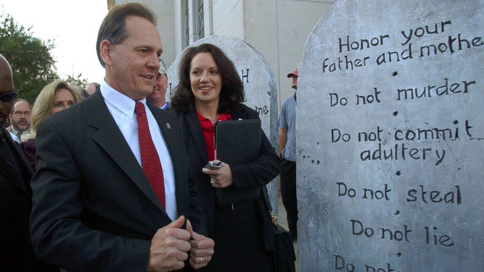 PHOTO:Roy Moore looking at a Ten Commandments display used in a rally as he arrives at the Judicial Building in Montgomery, Ala., Nov. 12, 2003.