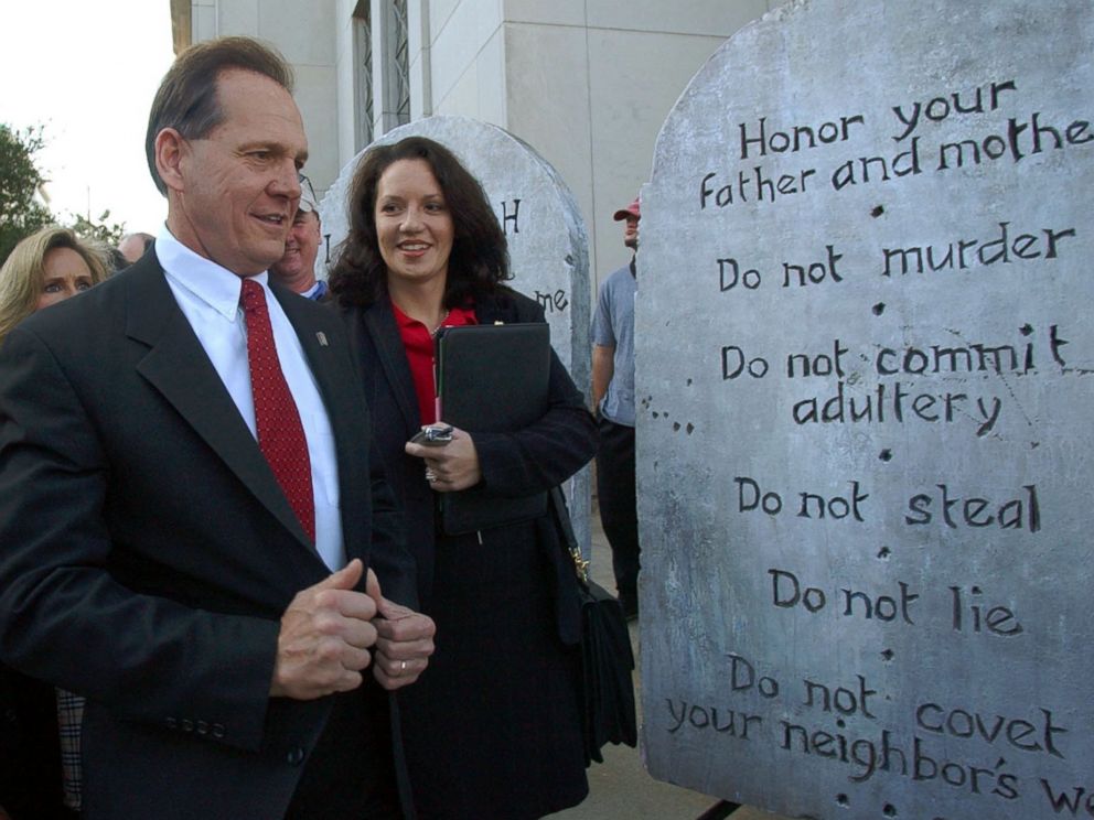 PHOTO:Roy Moore looking at a Ten Commandments display used in a rally as he arrives at the Judicial Building in Montgomery, Ala., Nov. 12, 2003. 
