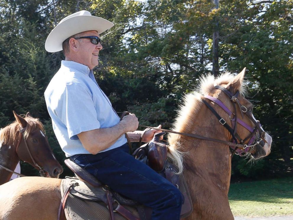 PHOTO: Alabama Republican U.S. Senate candidate Roy Moore on Sassy and wife Kayla on Sundance ride their horses to the Gallant Fire Hall to vote in the GOP runoff election Sept. 26, 2017 in Gallant, Ala. 