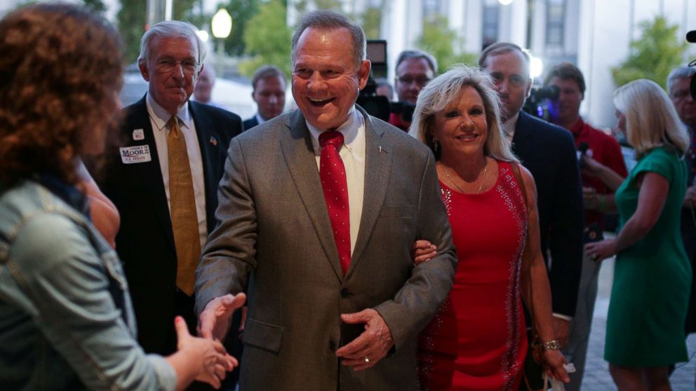 Republican candidate Roy Moore and his wife Kayla are greeted at the door as they arrive at the RSA Activity Center in Montgomery, Alabama, September 26, 2017, during the runoff election for the Republican nomination for Alabama's U.S. Senate seat.