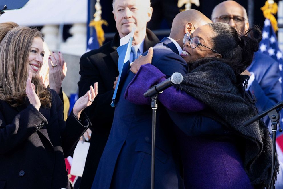 PHOTO: Chelsea Clinton and former Maryland Gov. Martin O'Malley look on as Gov. Wes Moore and Oprah Winfrey hug after Moore is sworn in as the 63rd governor of the state of Maryland, Jan. 18, 2023, in Annapolis, Md.