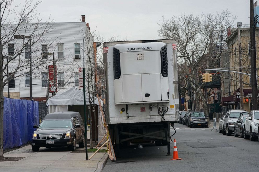 PHOTO: A hearse arrives to transport a body from a refrigeration truck serving as a temporary morgue outside of Wyckoff Hospital in the Bushwick section of Brooklyn, April 5, 2020, in New York.