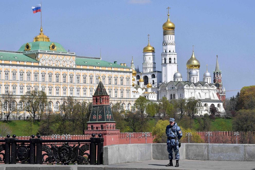 PHOTO: A member of the Russian National Guard stands guard on a bridge across the Moskva River, with the Kremlin seen in the background, in central Moscow on May 1, 2019.