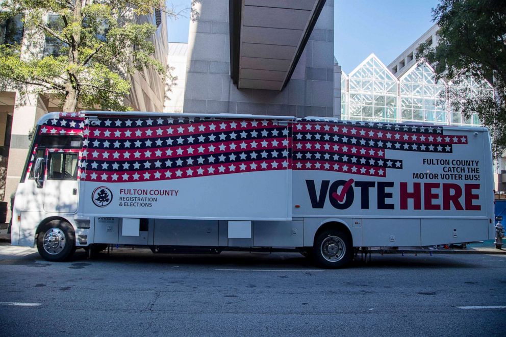 PHOTO: The new Fulton County mobile voting bus is featured during a news conference in downtown Atlanta, Thursday, Oct. 1, 2020. The bus will visit communities in Fulton County to provide extra booths for voting during this 2020 election season.