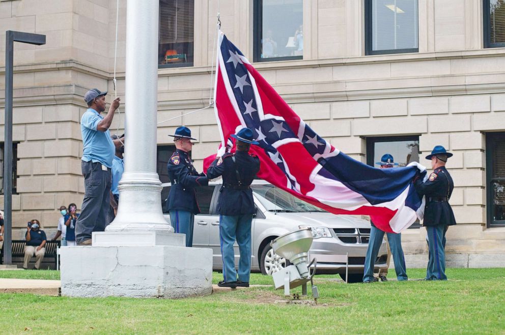 PHOTO: The Mississippi state flag is lowered and folded for the last time by the Mississippi Highway Patrol Honor Guard during a flag retirement ceremony at the state Capitol in Jackson, Miss., July 1, 2020.