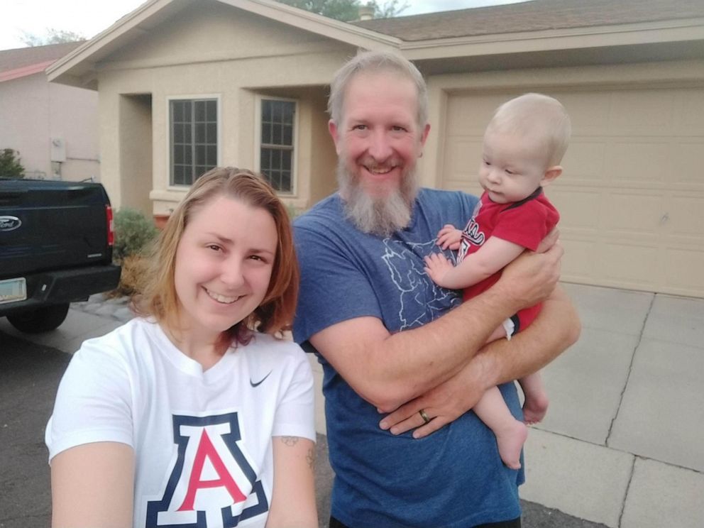 PHOTO: Maeghan Murdock stands with her husband and son outside of their new home in a Tucson, Arizona suburb that they were able to purchase with funds saved from federal stimulus dollars.