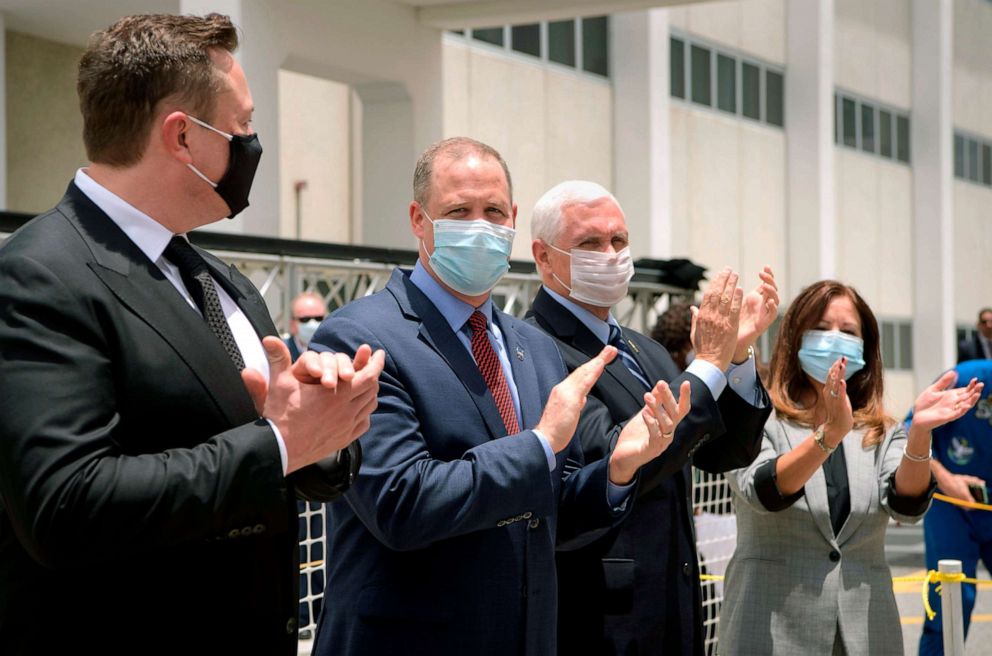 PHOTO: From left, Elon Musk, NASA Administrator Jim Bridenstine, Vice President Mike Pence, and Karen Pence, applaud as the NASA astronauts prepare to board the SpaceX Crew Dragon, May 27, 2020, at the Kennedy Space Center in Florida.