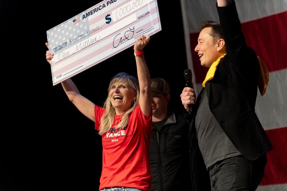 PHOTO: SpaceX and Tesla founder Elon Musk awarded Kristine Fishell with a $1 million check during the town hall at the Roxain Theater on October 20, 2024 in Pittsburgh, Pennsylvania.