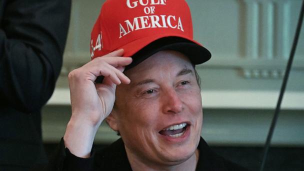 Elon Musk, wearing two hats, speaks during a cabinet meeting in the Cabinet Room of the White House in Washington, on April 30, 2025.
