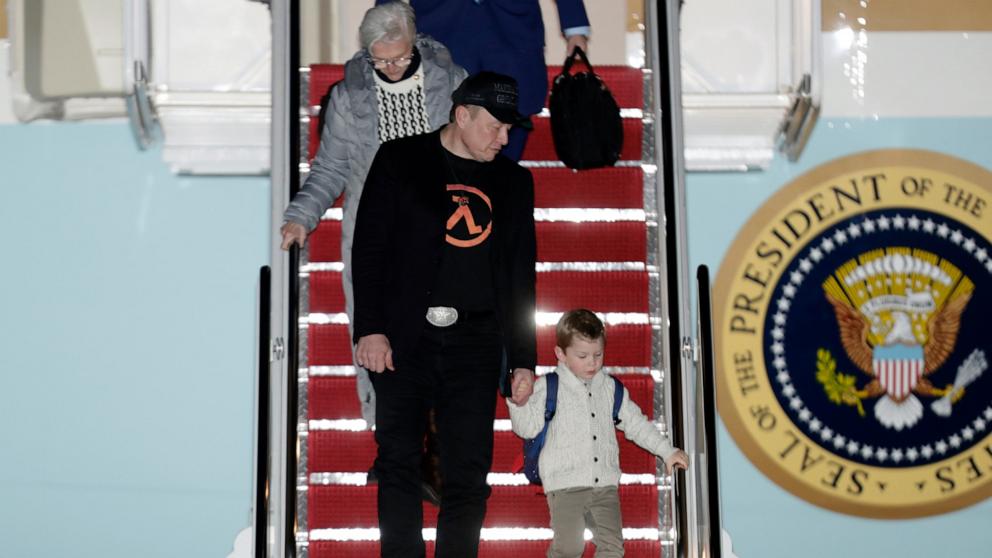 PHOTO: Elon Musk, front left, holds hands with his son, X Æ A-Xii, as he walks with his mother, Maye Musk, top left, down the stairs of Air Force One upon President Donald Trump's arrival at Joint Base Andrews, Md., March 2, 2025.