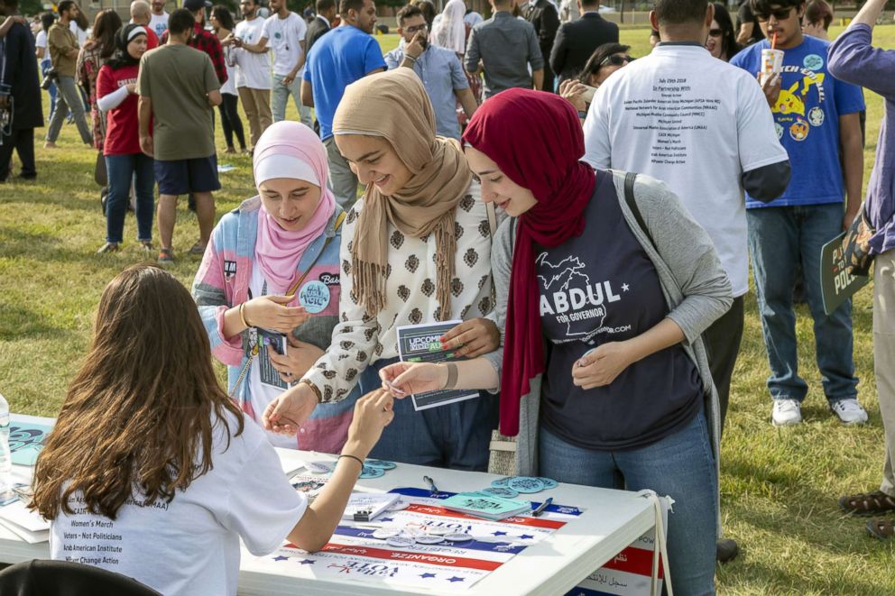 PHOTO: Women pick up literature at a "My Muslim Vote" rally in Dearborn, Mich., July 29, 2018.