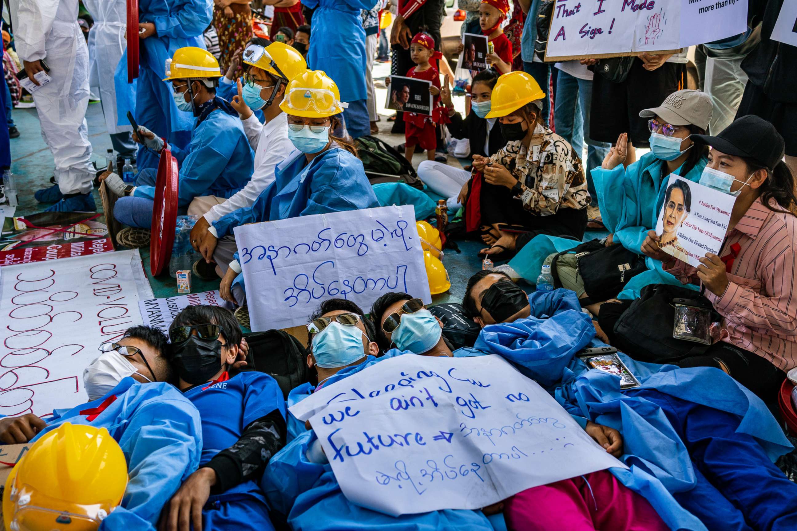 PHOTO: Protesters lies on the ground, Feb. 11, 2021 in Yangon, Myanmar. Myanmar declared martial law in parts of the country as massive protests continued to draw people to the streets a week after the country's military junta staged a coup.