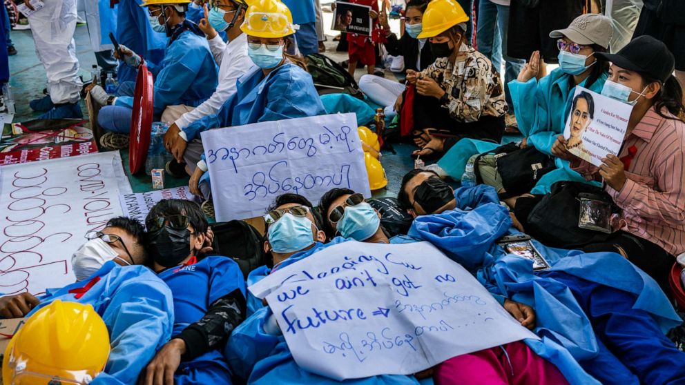 PHOTO: Protesters lies on the ground, Feb. 11, 2021 in Yangon, Myanmar. Myanmar declared martial law in parts of the country as massive protests continued to draw people to the streets a week after the country's military junta staged a coup.