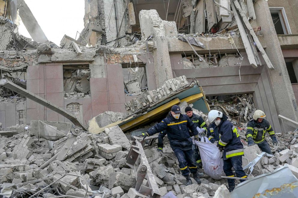 PHOTO: Firefighters carry a body from the rubble of a government building hit by Russian rockets in Mykolaiv, March 29, 2022.
