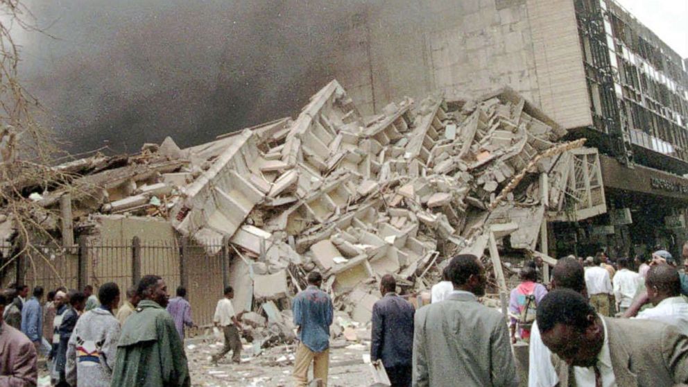 PHOTO: Passersby look at damaged buildings in Nairobi, Kenya, after a huge explosion ripped apart a building in the Kenyan capital, heavily damaging the American Embassy and killing at least 40 people and injuring dozens, Aug. 7, 1998.