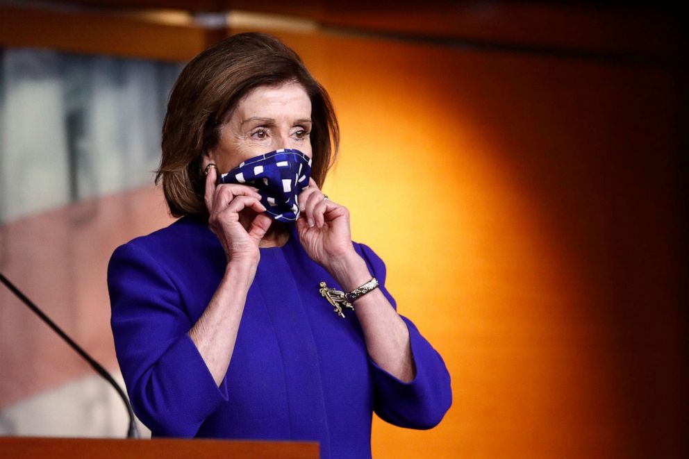 PHOTO: House Speaker Nancy Pelosi adjusts her face mask to protect against the spread of the new coronavirus as she attends a news conference on Capitol Hill in Washington, April 29, 2020.