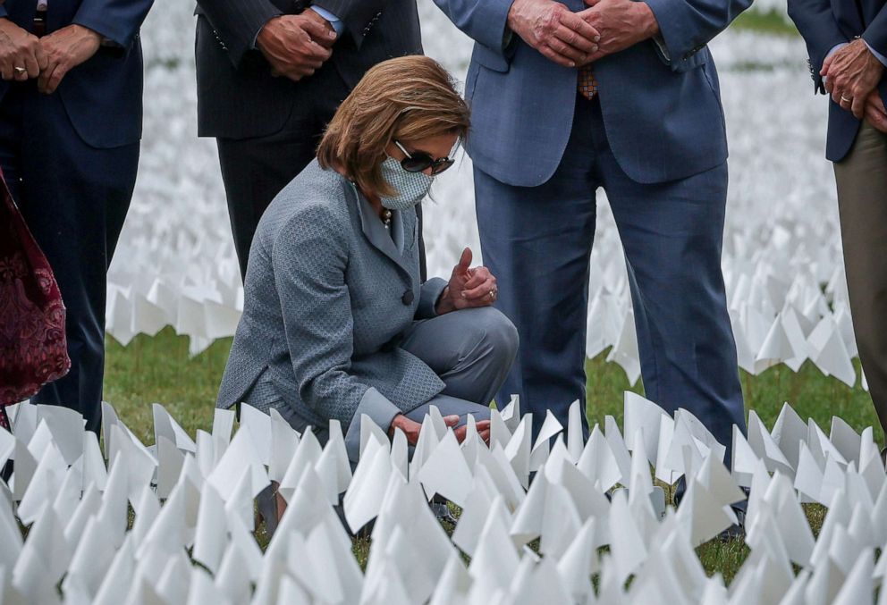 PHOTO: House Speaker Nancy Pelosi visits the art installation, In America: Remember, comprised of more than 600,000 flags commemorating all Americans who have died due to the coronavirus disease, located on the National Mall in Washington, Sept. 21, 2021.