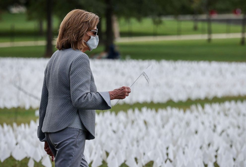 PHOTO: House Speaker Nancy Pelosi visits the art installation, In America: Remember, comprised of more than 600,000 flags commemorating all Americans who have died due to the coronavirus disease, located on the National Mall in Washington, Sept. 21, 2021.