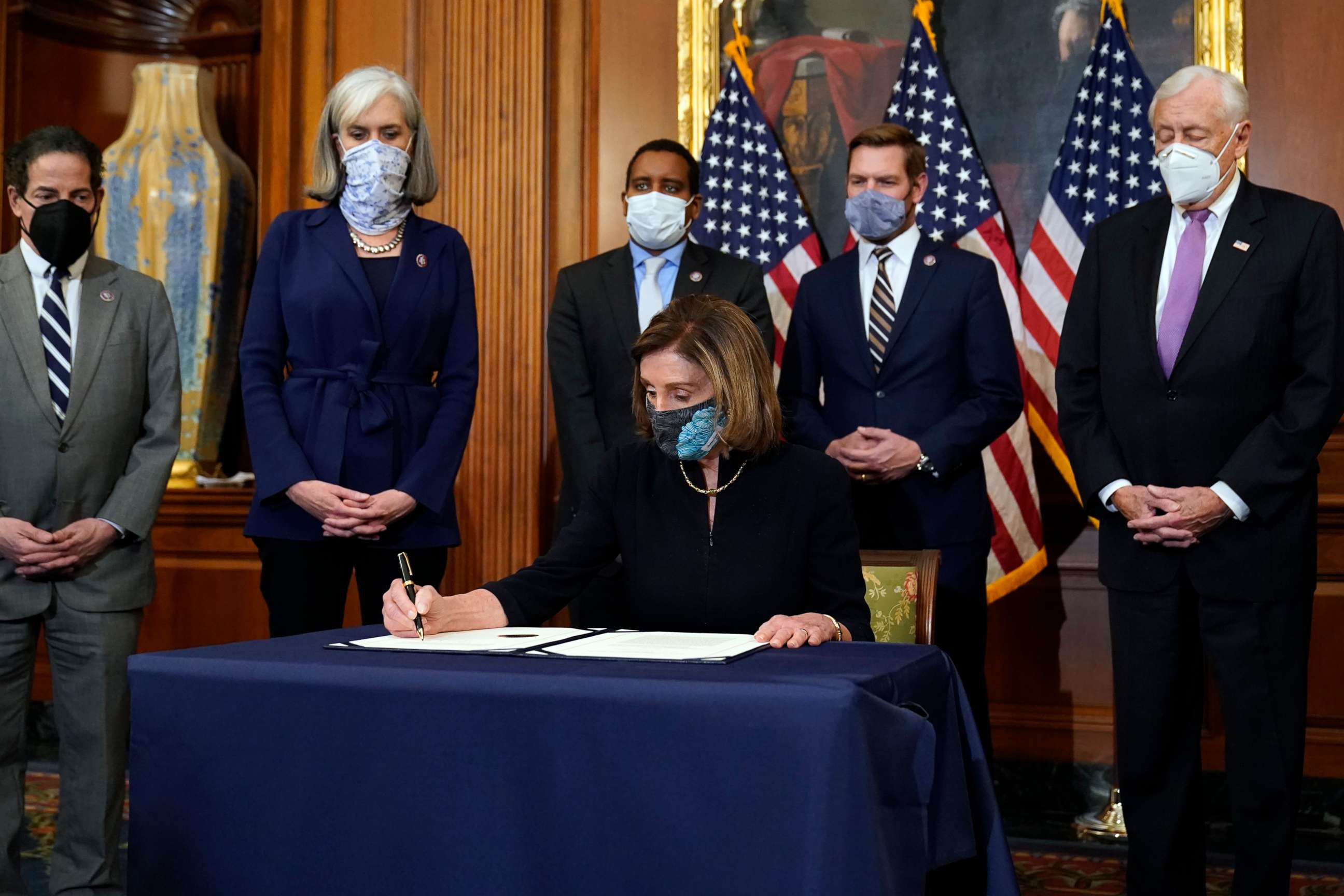 PHOTO: House Speaker Nancy Pelosi signs the articles of impeachment against President Donald Trump in an engrossment ceremony before transmission to the Senate for trial on Capitol Hill, in Washington, Jan. 13, 2021.