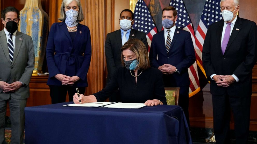 PHOTO: House Speaker Nancy Pelosi signs the articles of impeachment against President Donald Trump in an engrossment ceremony before transmission to the Senate for trial on Capitol Hill, in Washington, Jan. 13, 2021.