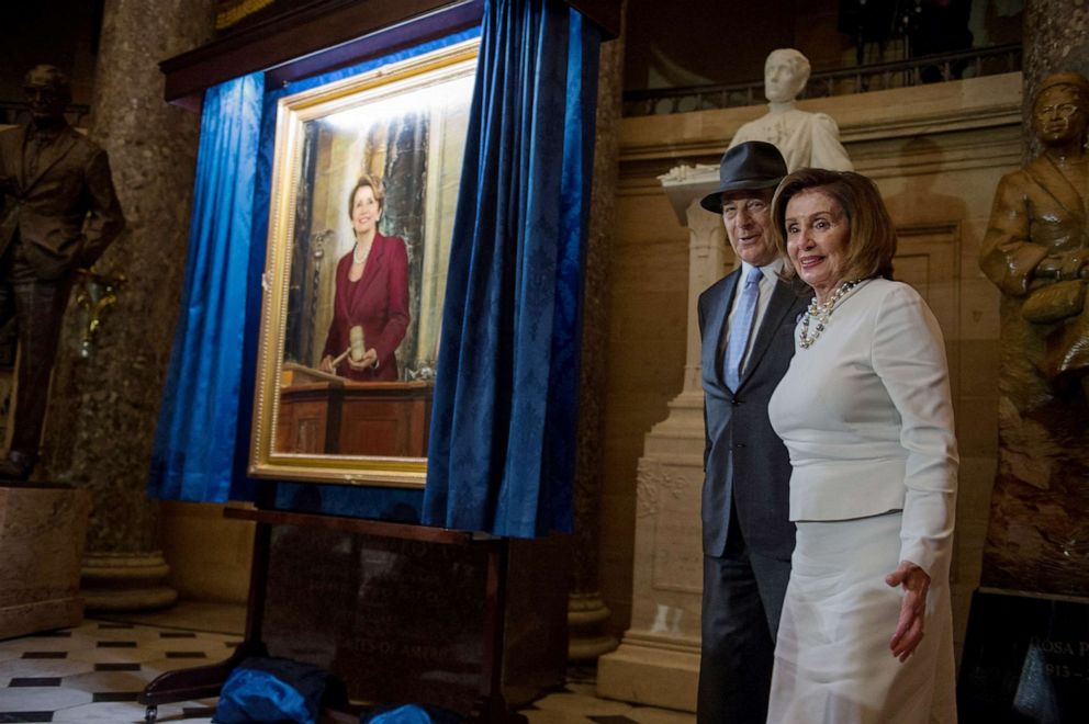 PHOTO: House Speaker Nancy Pelosi (D-CA) stands with her husband Paul as a portrait of her is unveiled at Statuary Hall in the U.S. Capitol, U.S., Dec. 14, 2022.