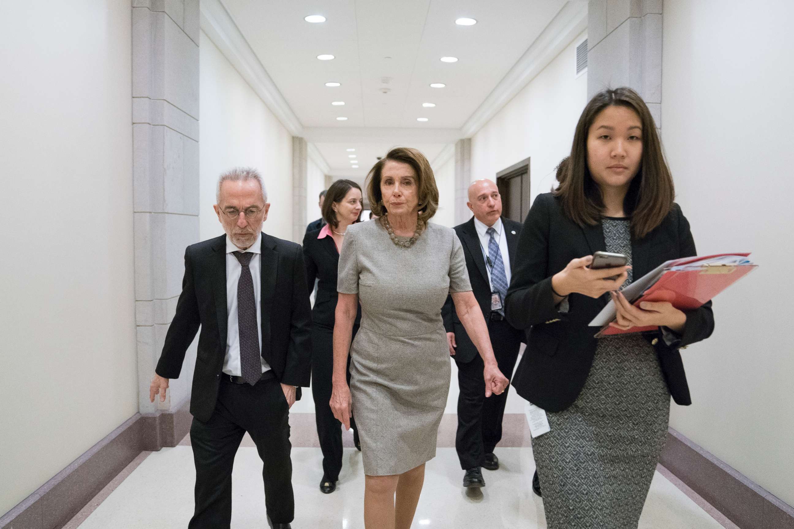 PHOTO: House Minority Leader Nancy Pelosi (D-Calif.), center, leaves a news conference with fellow House Democrats on the topic of infrastructure, Feb. 8, 2018, on Capitol Hill in Washington. 