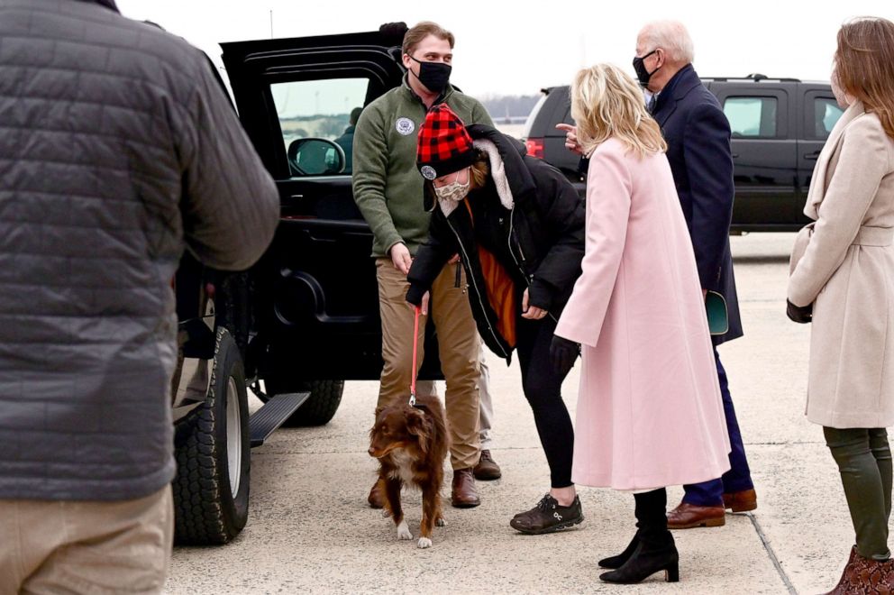 PHOTO: President Joe Biden and first lady Jill Biden look on as Biden's granddaughter Naomi and her boyfriend Peter Neal manage Naomi's dog after a trip to Camp David, at Joint Base Andrews, Md., Feb. 15, 2021.