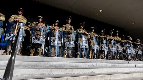 Members of the California National Guard stand guard outside the Federal Building before a curfew takes effect in Los Angeles, June 10, 2025, following days of protests in response to federal immigration operations that saw clashes spread across downtown. 