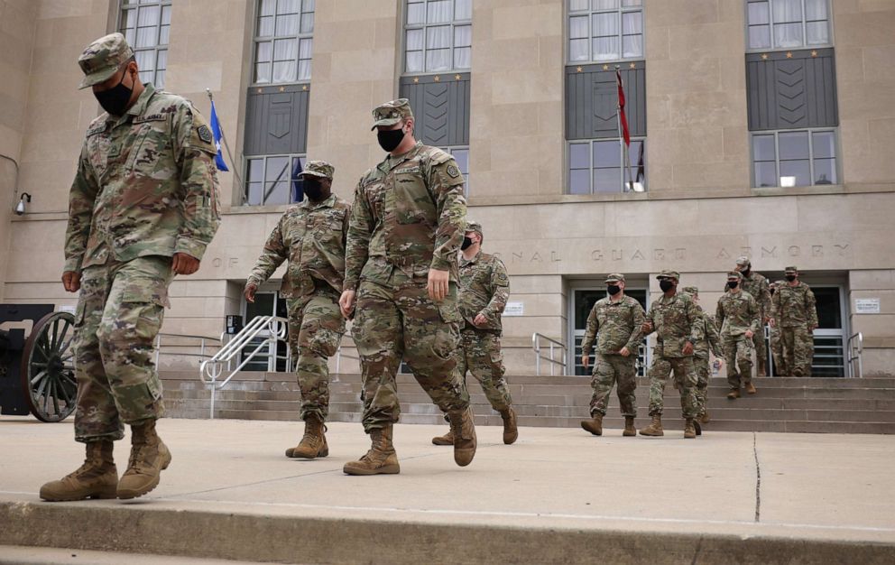 PHOTO: National Guard troops make their way to buses as they leave the Armory after ending their mission of providing security to the U.S. Capitol, May 24, 2021, in Washington, DC.