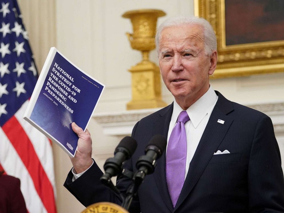 PHOTO: President Joe Biden speaks about the COVID-19 response as US Vice President Kamala Harris looks on before signing executive orders in the State Dining Room of the White House in Washington, D.C., Jan. 21, 2021.